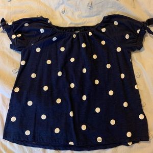 Navy blue and white polka dot girls blouse.